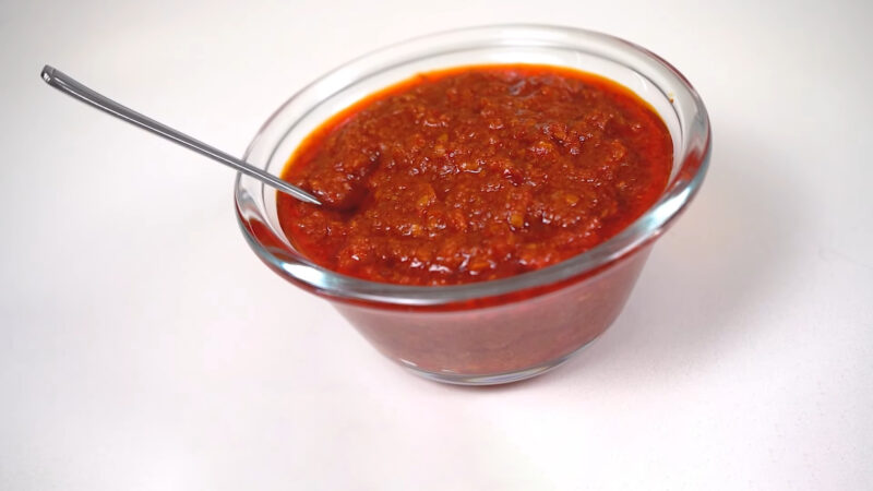Tomato Chili Sauce in small bowl with spoon